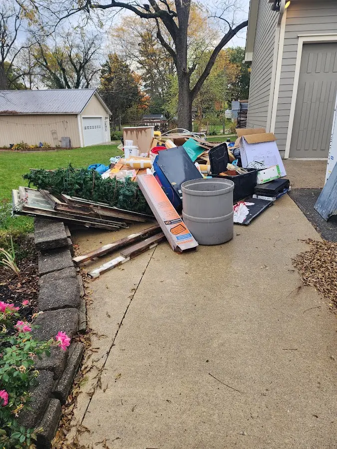 Dumpster being loaded with debris for Roofing Dumpster Rental in Sikeston